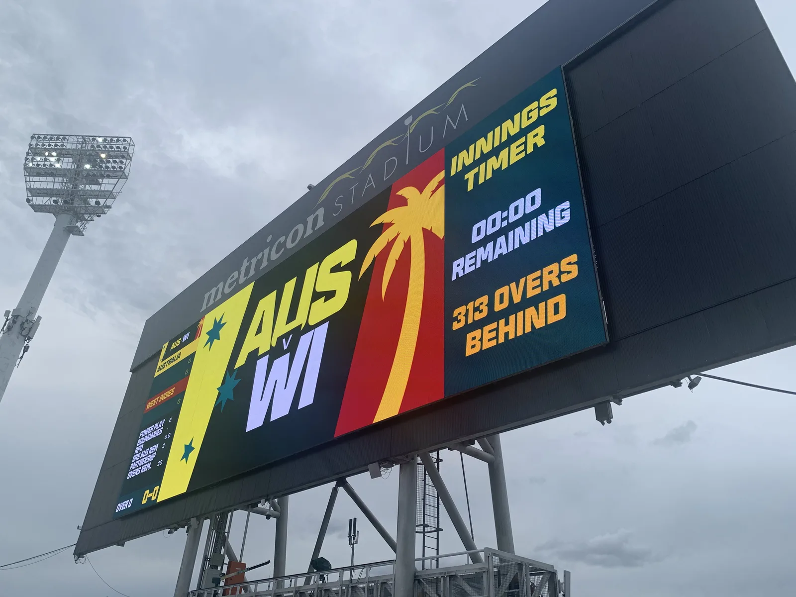 Aurora LED scoreboard at Metricon Stadium showing AUS v WI cricket innings timer and team graphics