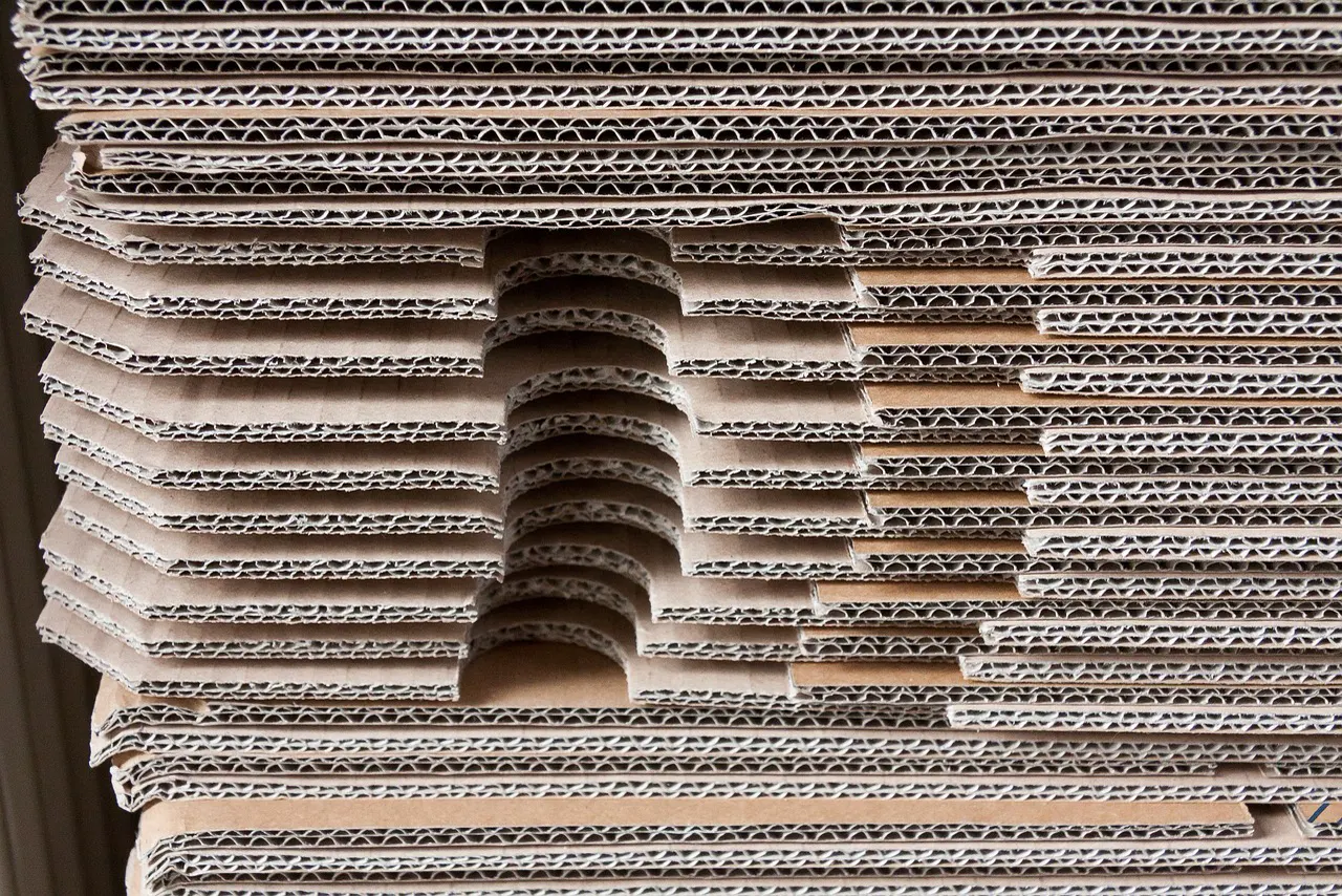 Stack of brown corrugated cardboard shipping cartons in a warehouse