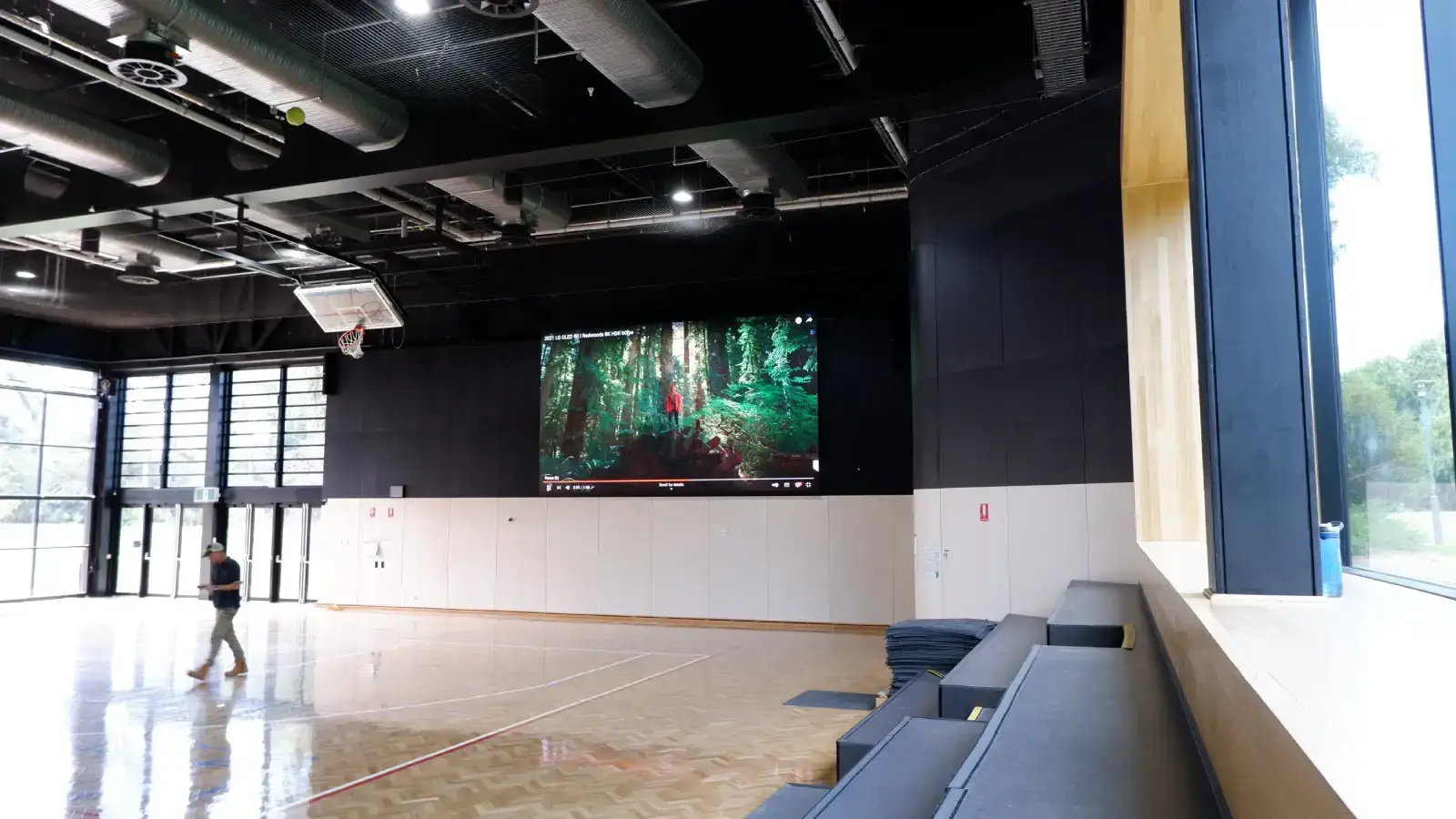 Aurora indoor LED display on gymnasium wall during a basketball session