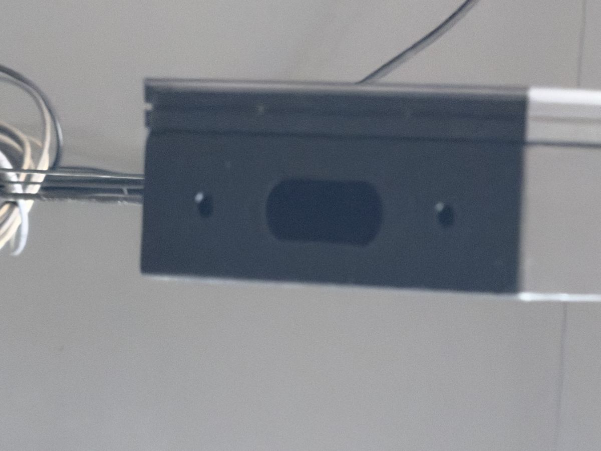Service cavity on rear of imported cabinet — direct access to live 240 VAC terminals