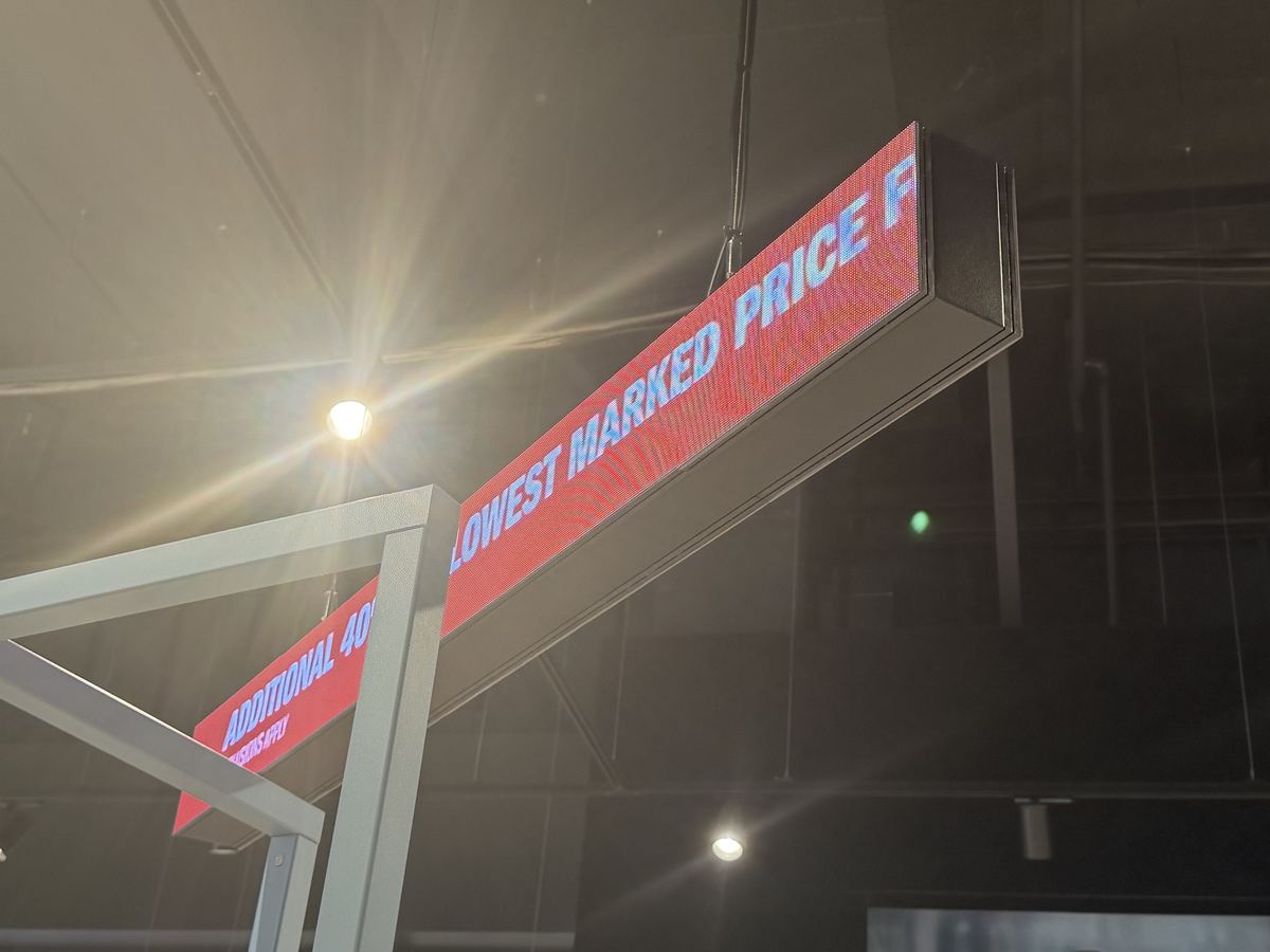 Welded steel-frame LED banner beam suspended from ceiling